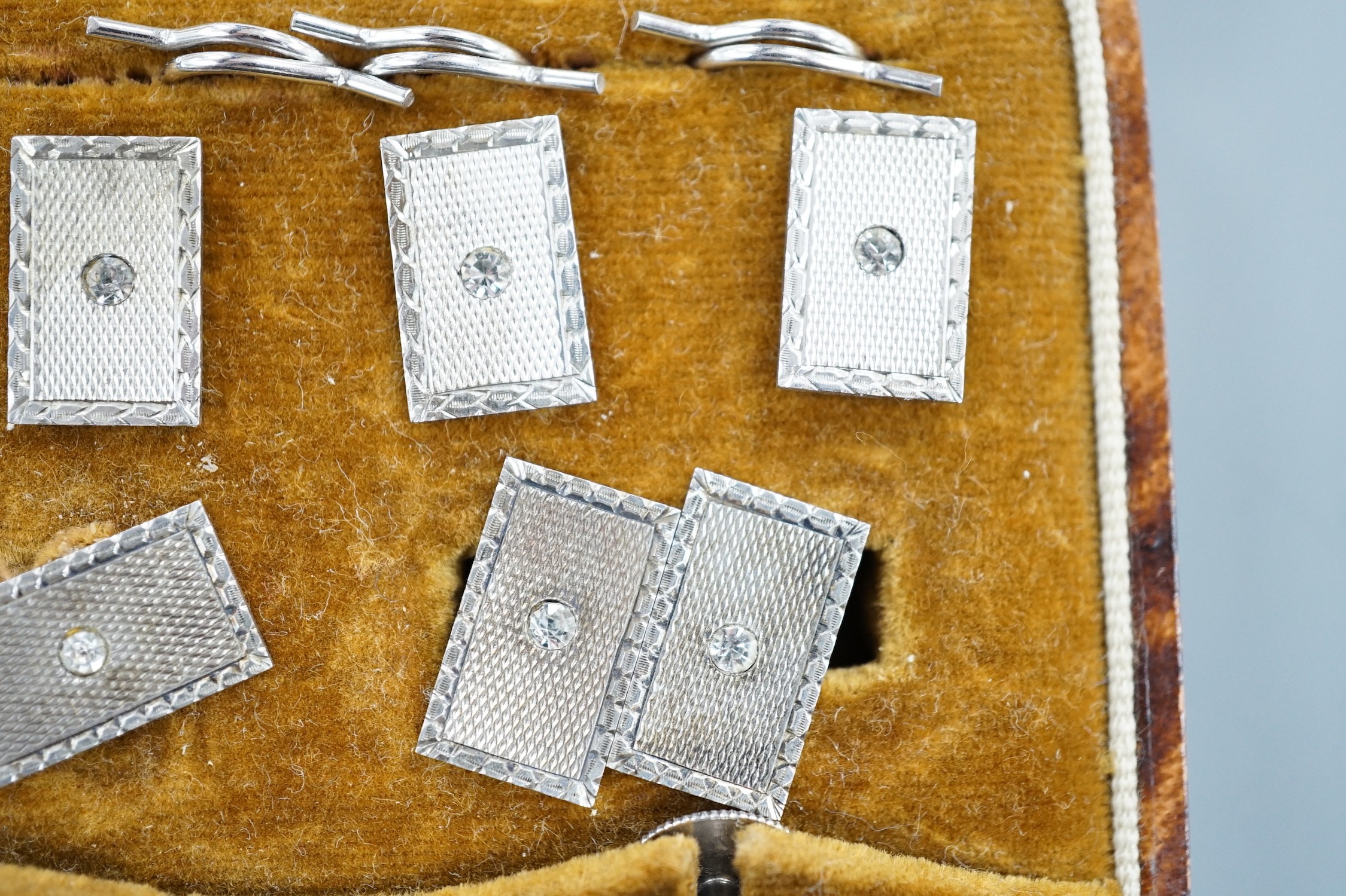 A cased 1930's engine turned silver eight piece dress stud set, by Henry Griffiths & Sons Ltd.